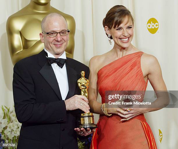 Dave Lebolt holds his award for scientific and technical design with presenter Jennifer Garner backstage during the 76th Annual Academy Awards at the...