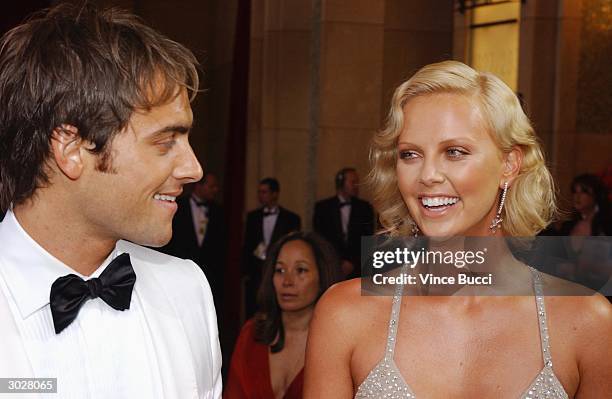 Actress Charlize Theron, nominated for Best Actress for her performance in "Monster" and actor Stuart Townsend attend the 76th Annual Academy Awards...