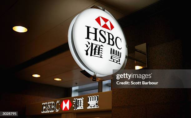 Sign featuring the logo of the banking giant HSBC hangs outside a branch on December 11, 2003 in Hong Kong. The London-based bank, which operates in...