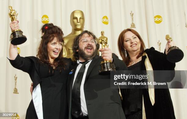 Writers Fran Walsh, Peter Jackson and Philippa Boyens pose with their Oscar for Best Adapted Screenplay for "The Lord of the Rings: The Return of the...