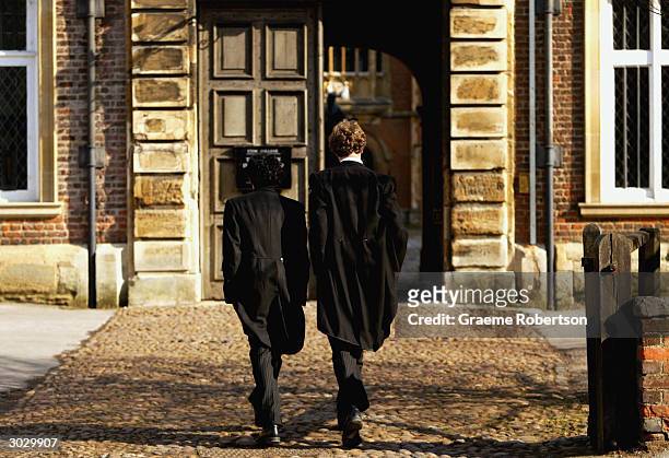 Pupils at Eton College hurry between lessons March 1, 2004 wearing the school uniform of tailcoats and starched collars, in Eton, England. Dozens of...