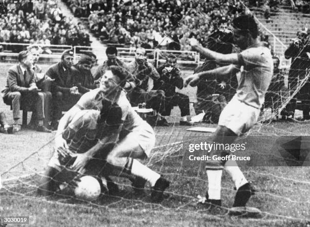 Brazilian football star Pele throws himself over the ball in the net after Brazil scored the single, winning goal of the World Cup quarteer final...