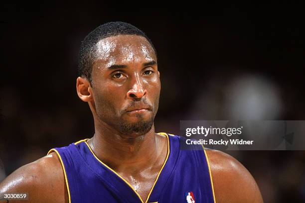 Kobe Bryant of the Los Angeles Lakers looks on during a break in game action against the Golden State Warriors on February 18, 2004 at the Arena in...