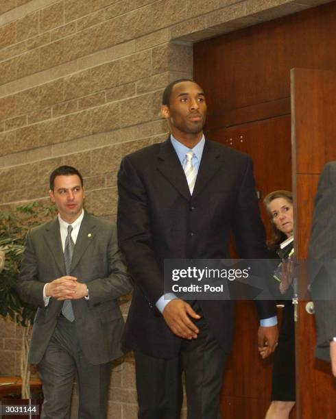 Kobe Bryant with security and Pam Mackey inside the Eagle County Justice Center during pretrial hearings March 1, 2004 in Eagle, Colorado. Bryant...