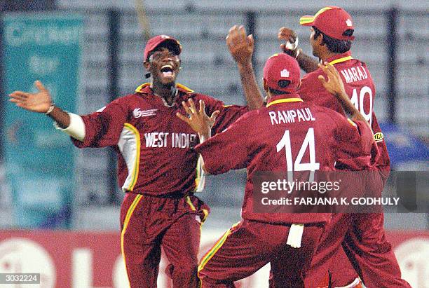 West Indies under 19 cricket team's cricketers celebrate the dismissal of England's batsman Michael Davies during the second semi-final match of the...