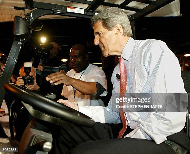 Democratic presidential candidate, Senator John Kerry , tries his hand on a forklift with the help of Chester Witchett at Roadway Express Shipping 02...