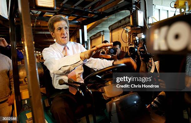 Democratic presidential candidate, Senator John Kerry , rides a forklift at a loading dock March 2, 2004 in Atlanta, Georgia. Kerry began Super...