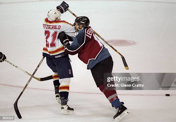 Defenseman Sylvain LeFebvre of the Colorado Avalanche in action against rightwinger Tom Fitzgerald of the Florida Panthers during the fourth game of...
