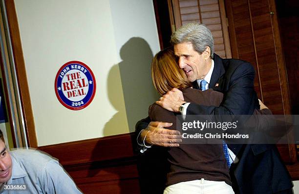 Democratic presidential candidate Senator John Kerry hugs a staff member as news reports say rival John Edwards is dropping out of the race March 2,...