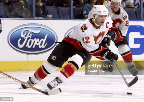 Jarome Iginla of the Calgary Flames controls the puck in the second period against the St. Louis Blues on March 2, 2004 at the Savvis Center in St....