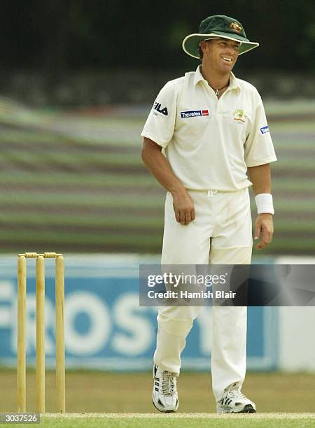Shane Warne of Australia wearing a Baggy Green Cap as well as a floppy white hat is seen during day two of the three day Tour Match between Australia...