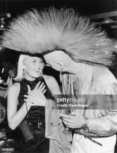 British 'Postcard punk' model Matt Belgrano greets English actress Patsy Kensit at a party to celebrate the 6th anniversary of the opening of...