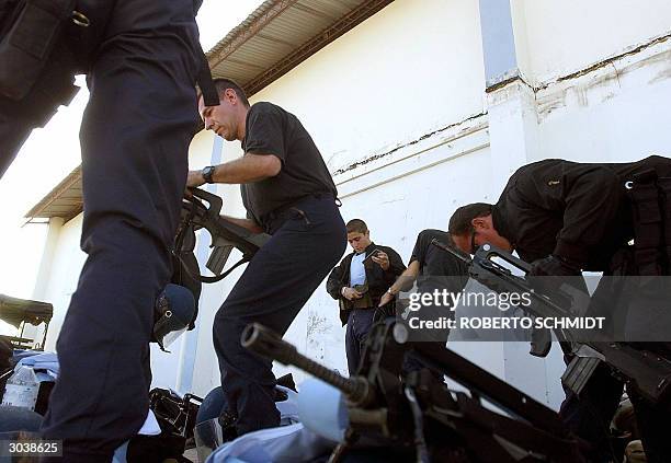 Newly arrived French Gendarmes organize their gear after arriving at Port-Au-Prince's International airport 03 March 2004. France, the US, and Canada...