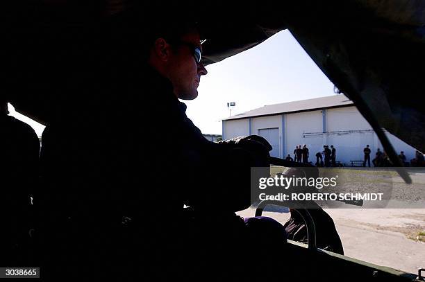 Newly arrived French Gendarme of the Gendarmerie Mobile unit looks out from inside a truck after arriving at Port-Au-Prince's International airport...