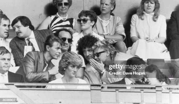 Bob Geldof has a word with Prince Charles, while David Bowie chats with Roger Taylor and Brian May of Queen, during the Live Aid Concert at Wembley...