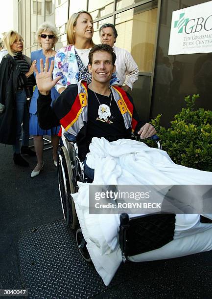 Eric LeMarque is followed by his mother Susan LeMarque and his stepmother Stella Lemarque as he is wheeled back into the Grossman Burn Center at...