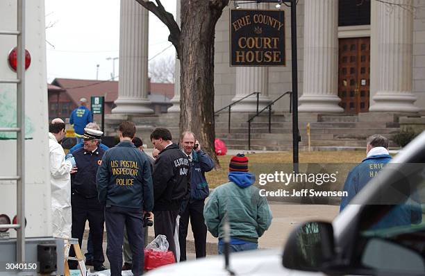 Postal Inspectors stand outside the Erie County Courthouse after a mysterious white powder was mailed to Erie Mayor Richard Fillippi, County D.A....