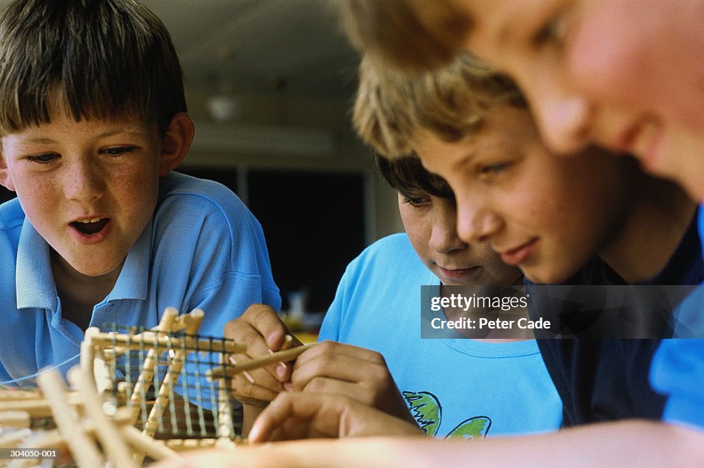 Schoolboys (7-9) working with construction model in classroom