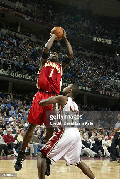 Stephen Jackson of the Atlanta Hawks shoots over Dajuan Wagner of the Cleveland Cavaliers March 3, 2004 at Gund Arena in Cleveland, Ohio. NOTE TO...