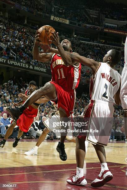 Jacque Vaughn of the Atlanta Hawks gets fouled by Dajuan Wagner of the Cleveland Cavaliers March 3, 2004 at Gund Arena in Cleveland, Ohio. NOTE TO...