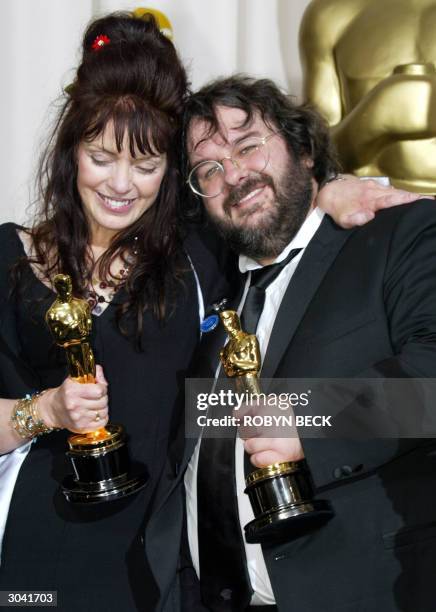 Fran Walsh and director Peter Jackson pose with their Oscar for Best Adapted Screenplay at the 76th Academy Awards ceremony 29 February, 2004 at the...