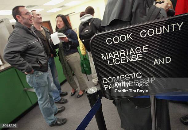 Chicagoans Keith Amoroso , with glasses, and partner Glenn Charbonneau are interviewed after attempting to apply for a marriage license March 4, 2004...