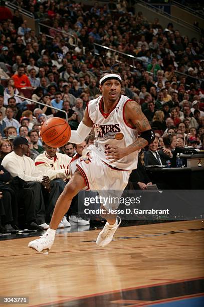 Allen Iverson of the Philadelphia 76ers drives to the net against the defense of the Sacramento Kings on March 4, 2004 at the Wachovia Center in...