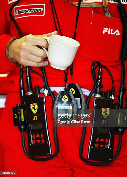 Jean Todt of the Ferrari Formula One Team has a cup of tea in the pits during practice for the 2004 Australian Grand Prix which is round one of the...