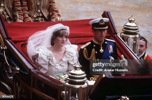 Prince Charles, Prince of Wales and Diana, Princess of Wales, wearing a wedding dress designed by David and Elizabeth Emanuel and the Spencer family...