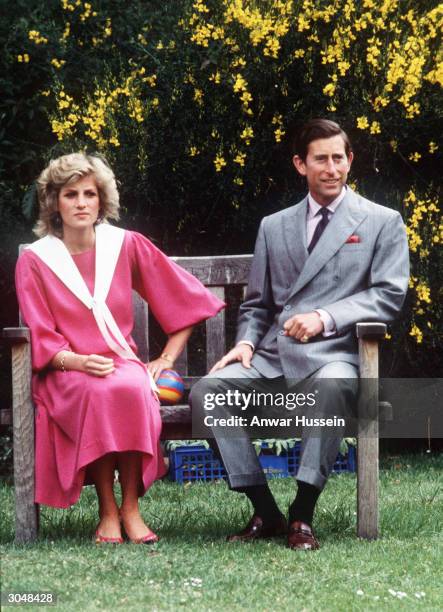 Prince Charles, Prince of Wales and Diana, Princess of Wales, while 6 months pregnant with Prince Harry and wearing a pink sailor style dress with a...