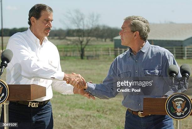 President George W. Bush and Mexican President Vicente Fox shake hands during a joint news conference on Bush's ranch March 6, 2004 in Crawford,...
