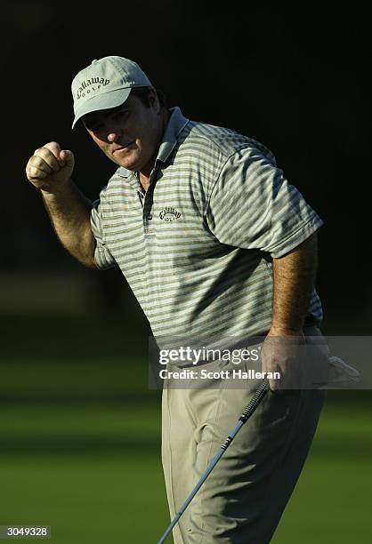 Craig Parry of Australia celebrates a par putt on the 15th green during the third round of the Ford Championship at the Doral Golf Resort and Spa on...