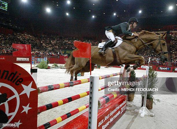 Baloubet du Rouet carries Rodrigo Pessoa to victory in the FEI World Equestrian Games obstacle-jumping competition at Bercy Sports Center in Paris 06...