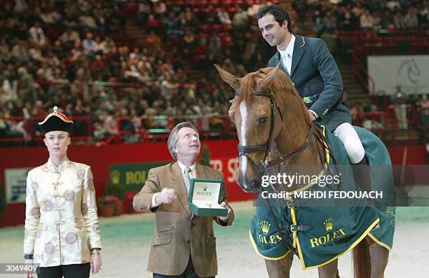 Baloubet du Rouet carrying Rodrigo Pessoa are awarded the Prix Rolex after winning the FEI World Equestrian Games obstacle-jumping competition at...