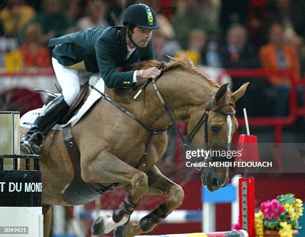 Baloubet du Rouet carries Brazilian Rodrigo Pessoa to victory in the FEI World Equestrian Games obstacle-jumping competition at Bercy Sports Center...