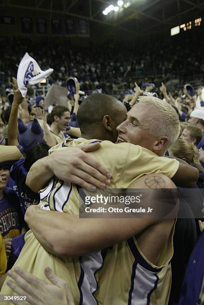 Mike Jensen of the Washington Huskies hugs Curtis Allen after beating the Stanford Cardinal 75-62 on March 6, 2004 at Hec Edmundson Pavilion in...