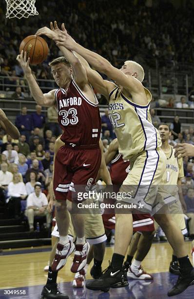 Matt Lottich of the Stanford Cardinal rebounds against Mike Jensen of the Washington Huskies on March 6 2004 at Hec Edmundson Pavilion in Seattle,...
