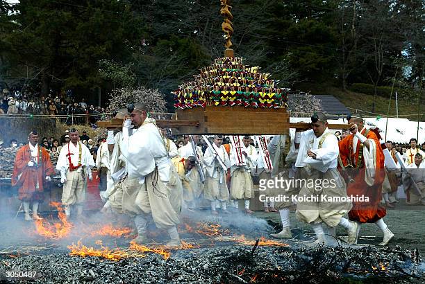 Ascetic monks and other participants walk barefoot on fire during Nagatoro Himatsuri at Daigoji Temple March 7, 2004 in Saitama, Japan. This is an...