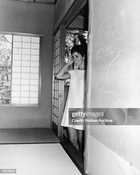 French singer and actor Claudine Longet smiles as she enters a tearoom in the Tatsumura Silk Mansion, Kyoto, Japan, circa 1968.