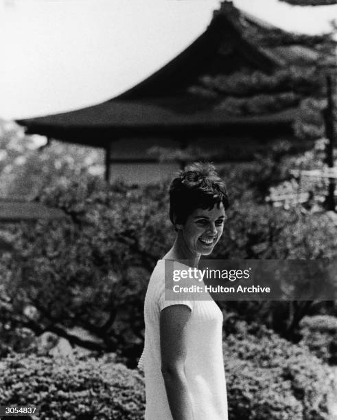 French singer and actor Claudine Longet smiles as she stands outdoors during a visit to Japan, circa 1968.