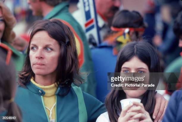French singer and actor Claudine Longet holds her amr around her daughter Noelle while watching a skiing event in Aspen, Colorado, March 1976.