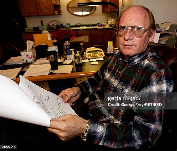Richard Holm of Colorado City, Arizona, goes over Lawsuit papers that were just served on him that morning March 3, 2004 by the Fundamentalist Church...
