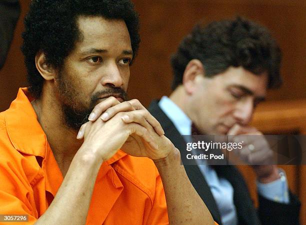 Convicted sniper John Allen Muhammad listens to testimony as his attorney Jonathan Shapiro sits next to him prior to being sentenced for the shooting...