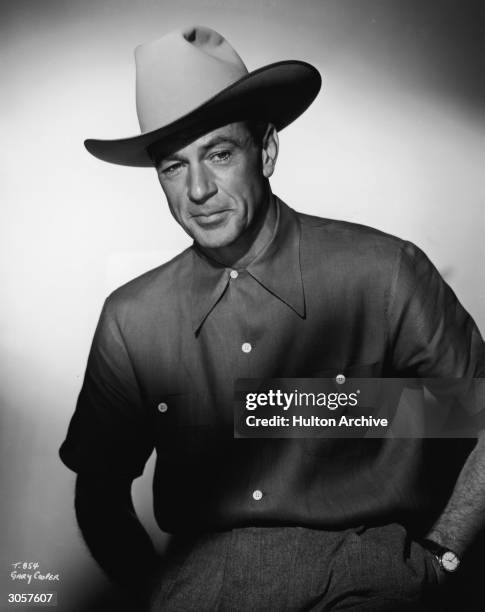 Portrait of American actor Gary Cooper , dressed in a cowboy hat and a short-sleeved shirt, 1950s.