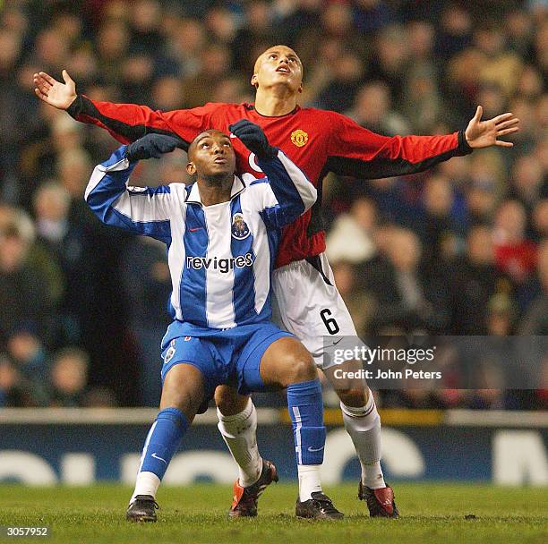 Wes Brown of Manchester United clashes with Benni McCarthy of FC Porto during the UEFA Champions League match between Manchester United and FC Porto...
