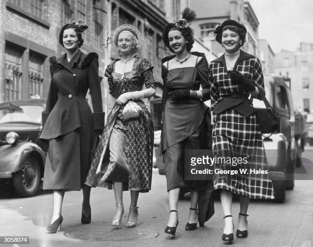 Four ladies, dressed to the nines, arrive at the London Coliseum for a presentation by the Apparel and Fashion Industry's Association, held during...