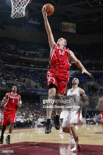 Eric Piatkowski of the Houston Rockets lays up a shot past Carlos Boozer of the Cleveland Cavaliers during the game at Gund Arena on December 17,...