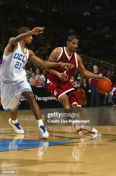 Marcus Moore of the Washington State Cougars is defended by Cedric Bozeman of the UCLA Bruins during the game at Pauley Pavillion on February 5, 2004...