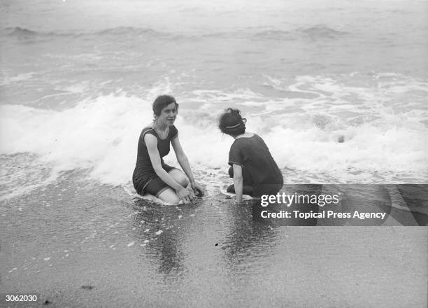 Two friends on the beach at Aberystwyth, Cardiganshire, wearing Victorian swimming costumes.