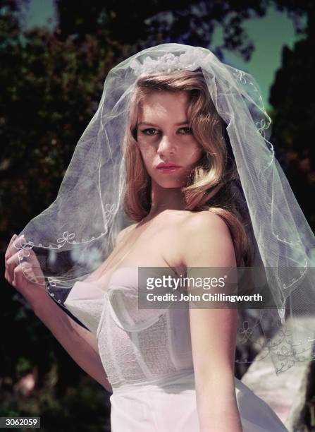 French actress Brigitte Bardot, nicknamed the Sex Kitten, wearing a wedding veil. Original Publication: Picture Post - 8546 - Brigitte Bardot - unpub.